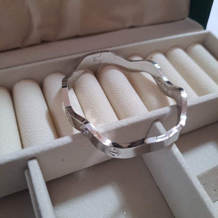 دستبند بنگل موجدار لولایی نقرهای براق با حکاکی Cartier | طراحی لوکس و مینیمال برند استینلس استیل